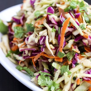 Ginger Asian coleslaw is packed with fresh flavors like ginger, peanut butter, apple cider vinegar, and cilantro! It's sweet, tangy, crunchy, and delicious as a side dish or to top burgers, sandwiches, and wraps!