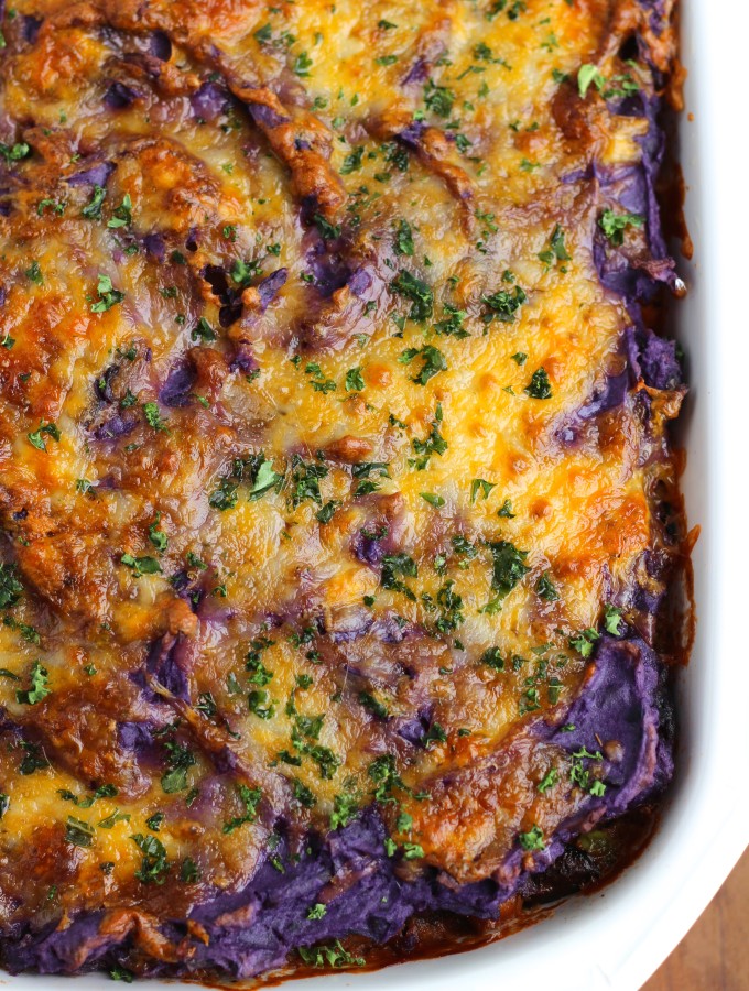 Vegetable Shepherd's pie is loaded with sauteed crimini mushrooms, chick peas, and mixed veggies. Topped with creamy purple mashed potatoes. This is our favorite fall casserole! Vegetarian.