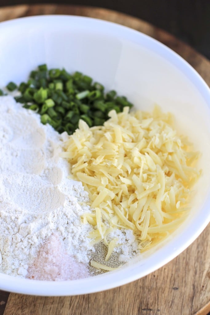 A large white mixing bowl filled with ingredients to make the bread.