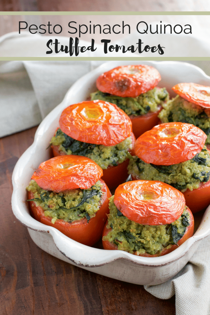 A white casserole dish filled with vegan stuffed tomatoes on a rustic background. 