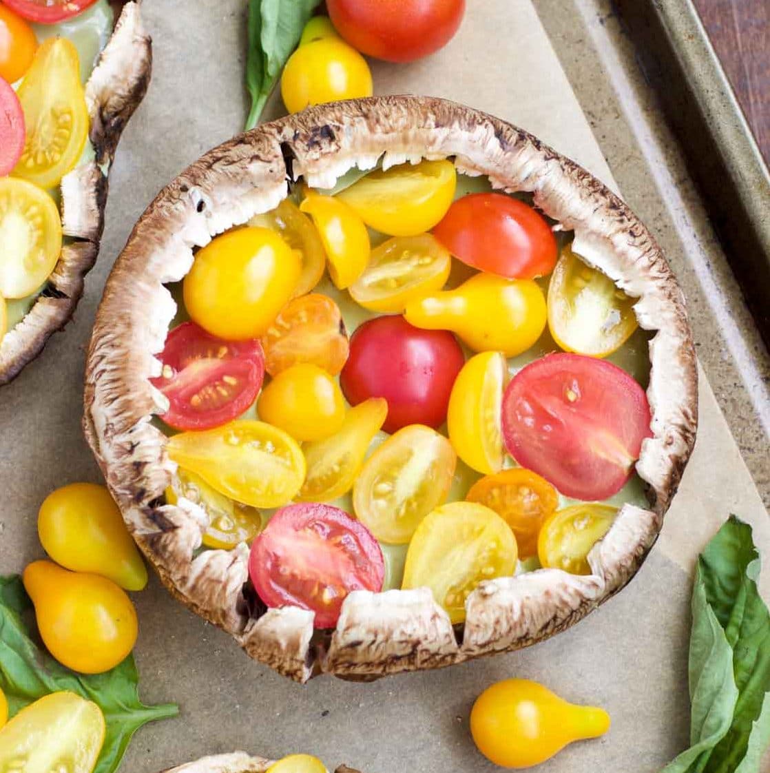 Overhead shot of a vegan stuffed mushroom on a parchment paper lined tray.