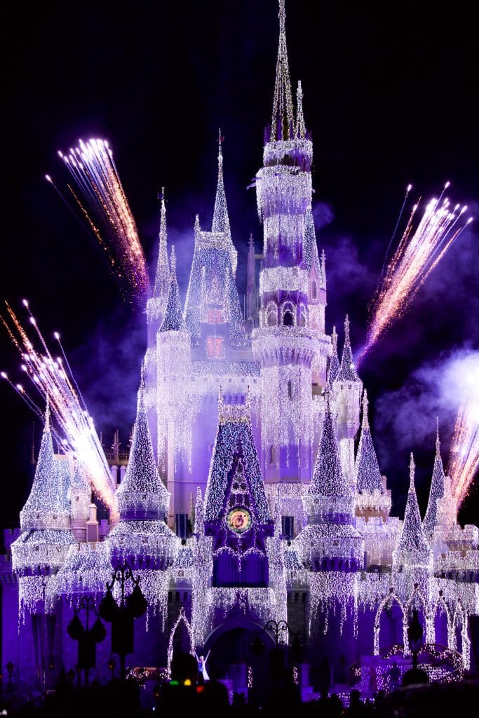 Cinderella Castle shooting off fireworks during the Disney World Christmas party. 