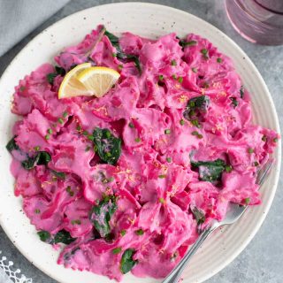 pink pasta on a white plate