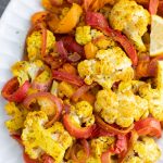 Roasted lemon turmeric basil vegetables are coated in a bright & tangy sauce. Pair it with a quinoa bowl, chicken or fish for a healthy dinner! Vegan.