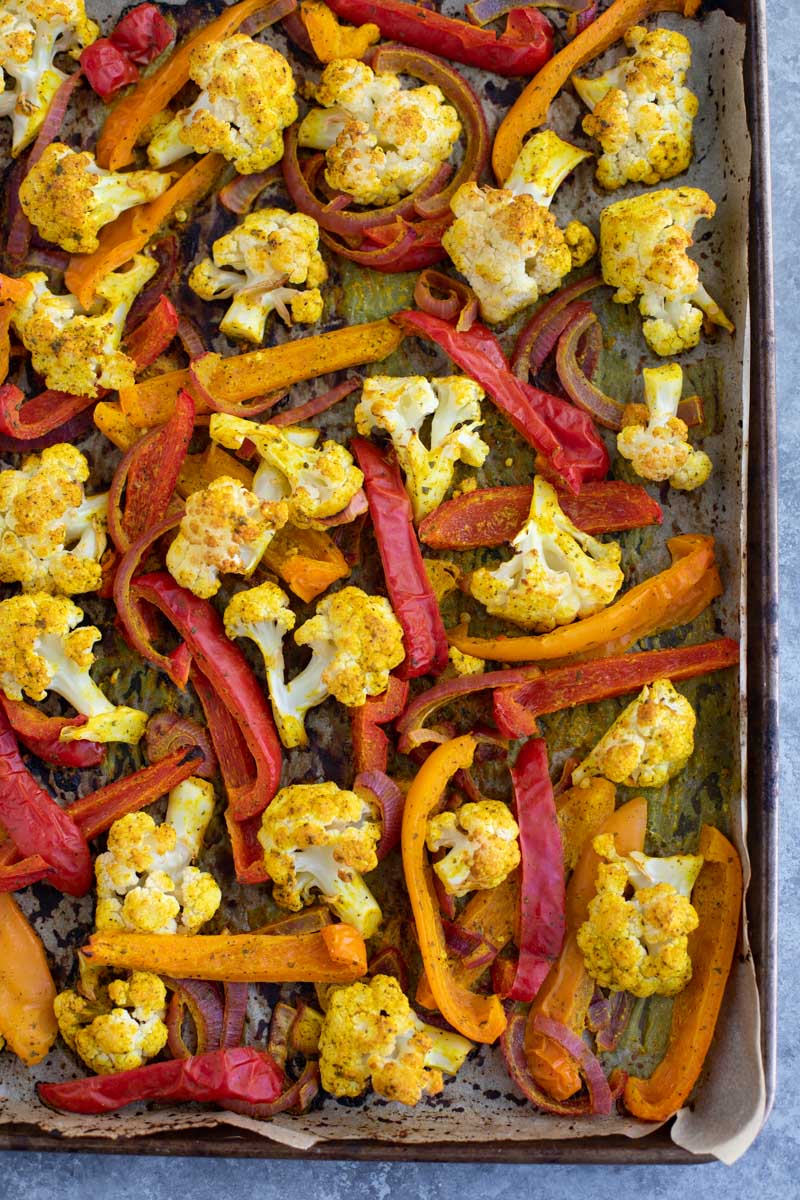 Roasted vegetables on a parchment-lined tray. 