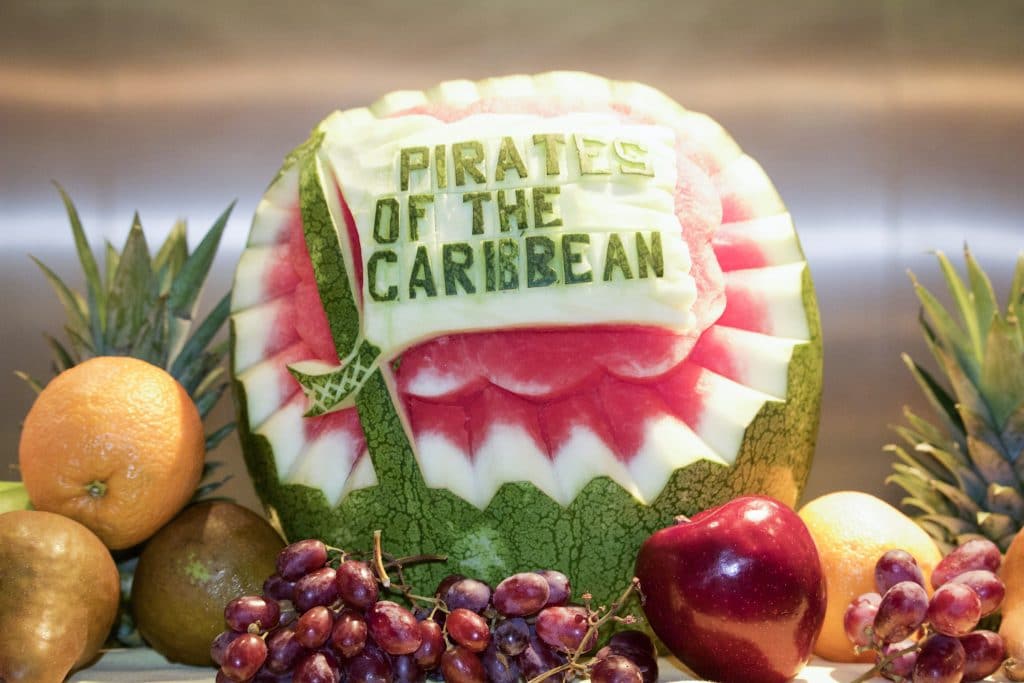 A watermelon with the words "pirates of the Caribbean" carved into the side.