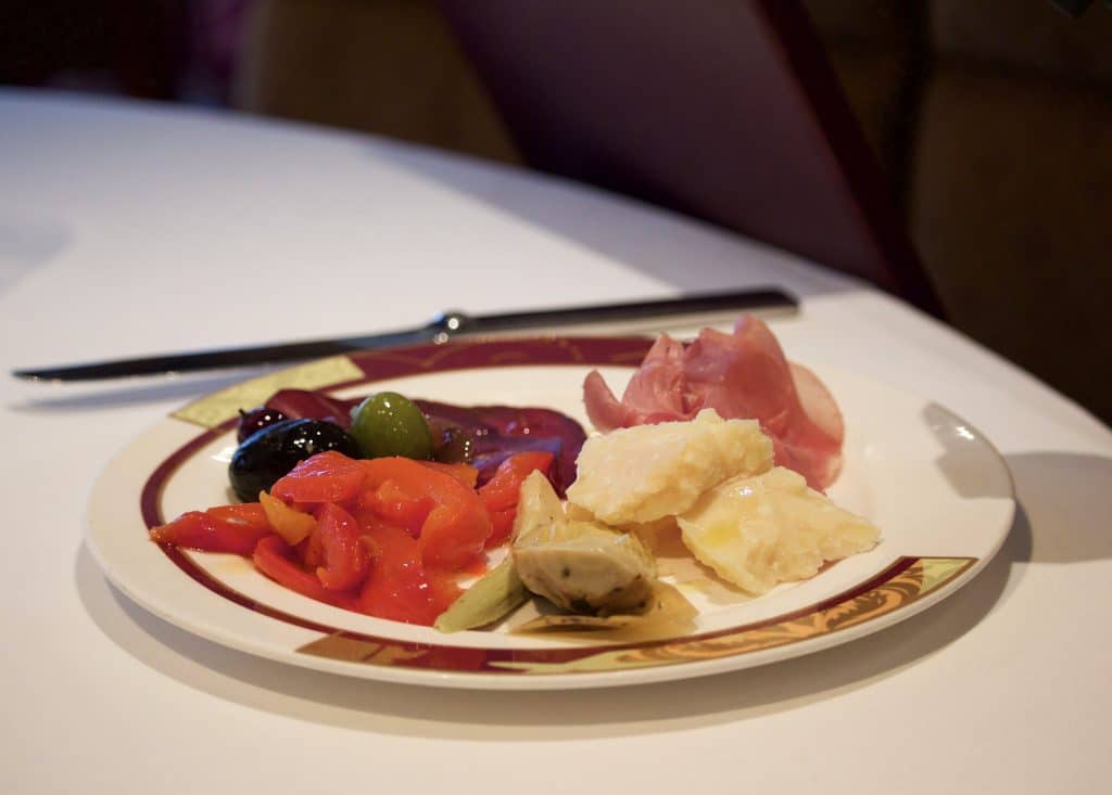 A plate filled with charcuterie at dinner at Palo on the Disney Fantasy. 