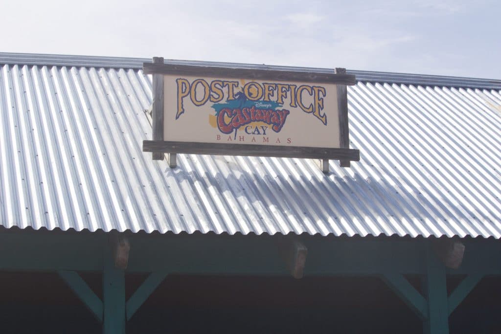 Castaway Cay post office sign on top of the building. 