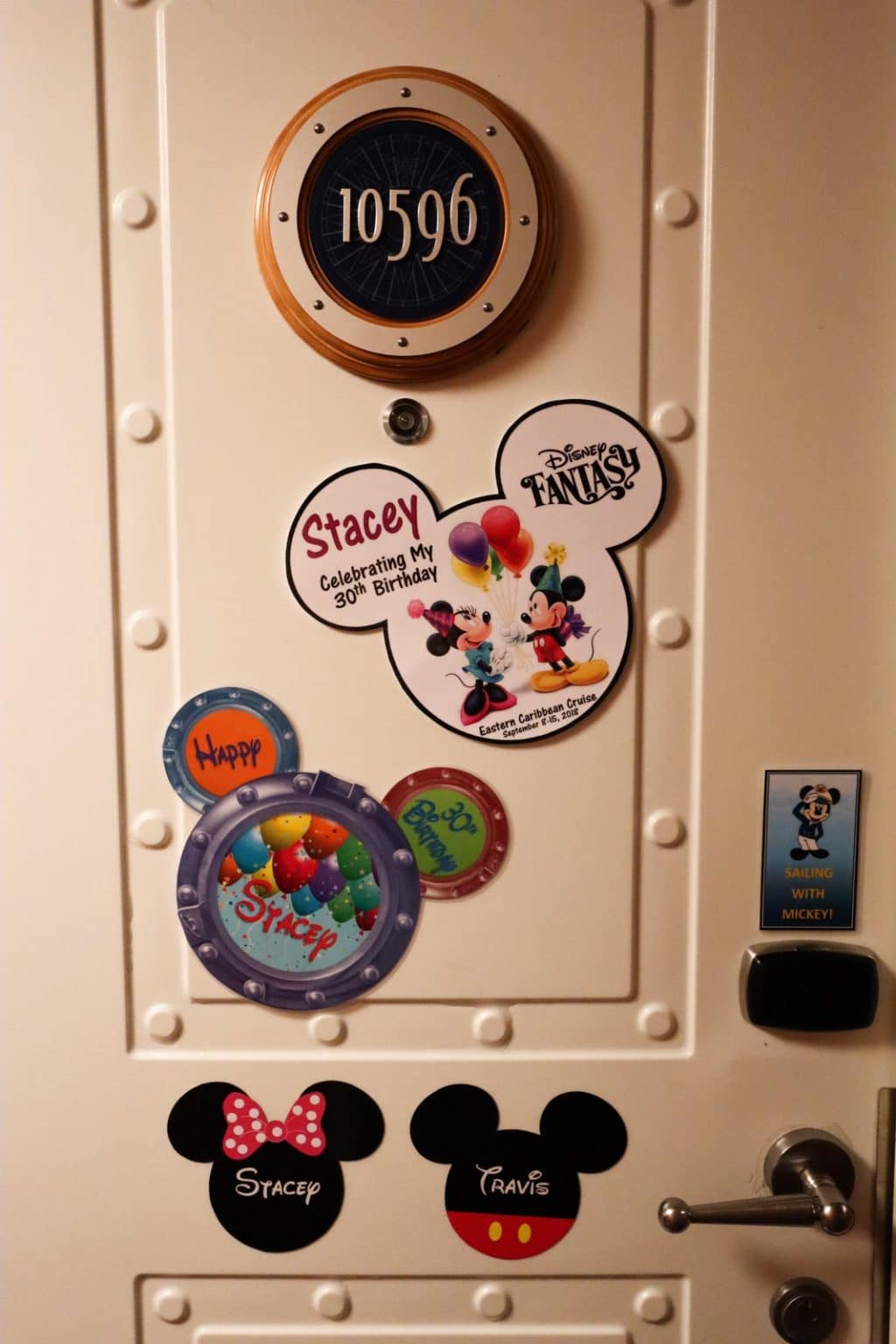 Stateroom #10596 on the Disney Fantasy decorated with Disney-themed magnets. 