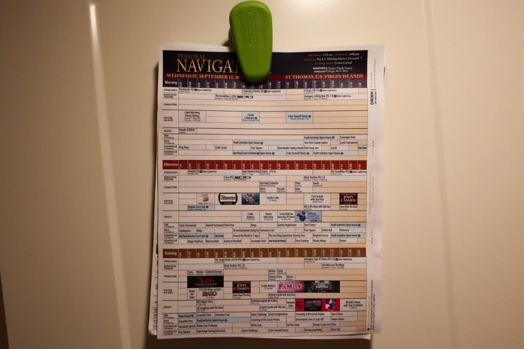 Disney cruise personal navigator's clipped and hanging on a door. 