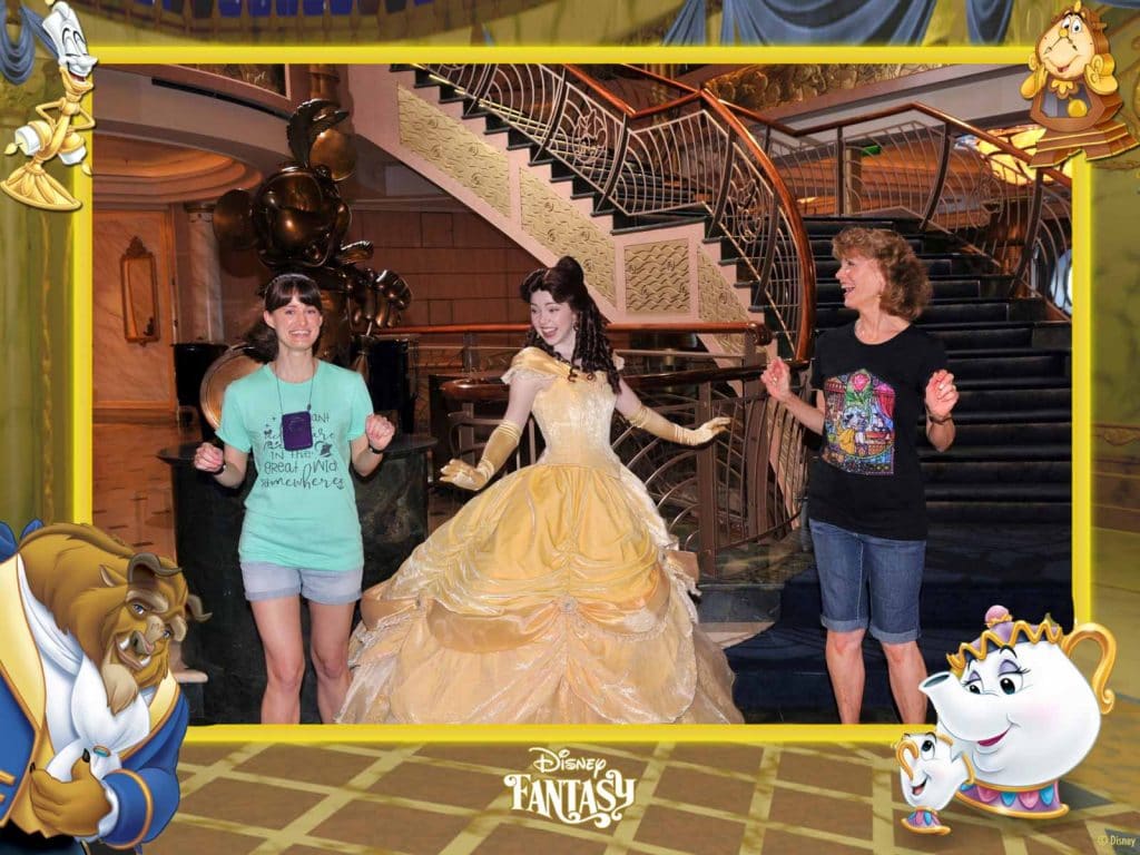 A happy mother and daughter are dancing with Belle at the princess meet and greet on the Disney Fantasy.