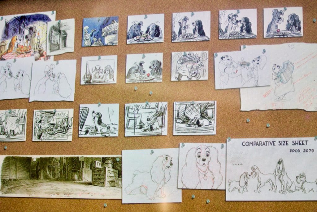 Disney drawings pinned to a cork board. 