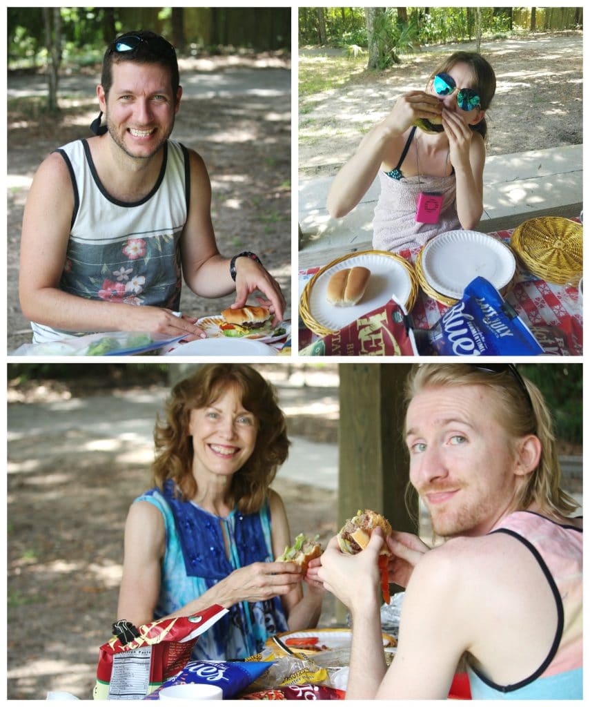 A family eating burgers on a picnic table under the pavilion at Rainbow Springs State Park. 