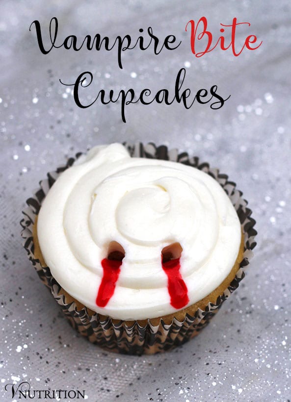 A cupcake with a bloody vampire bite mark in the frosting on a sparkly background.