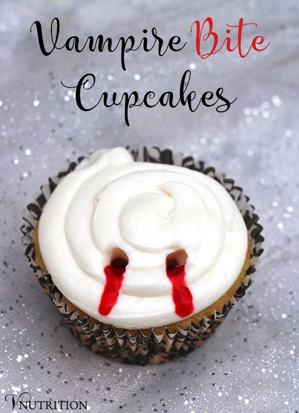 A cupcake with a bloody vampire bite mark in the frosting on a sparkly background.