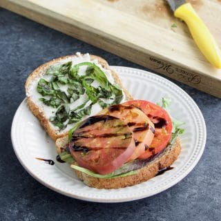 This heirloom tomato caprese sandwich recipe is one of our favorite easy vegan lunches! It's everything you love about caprese salad but in sandwich form + it's ready in 5 min! Vegan, dairy-free.