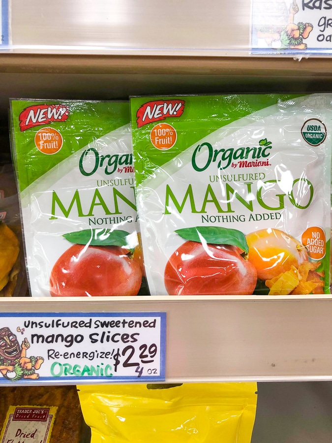 Two bags of organic dried mango on a shelf at Trader Joe's. 