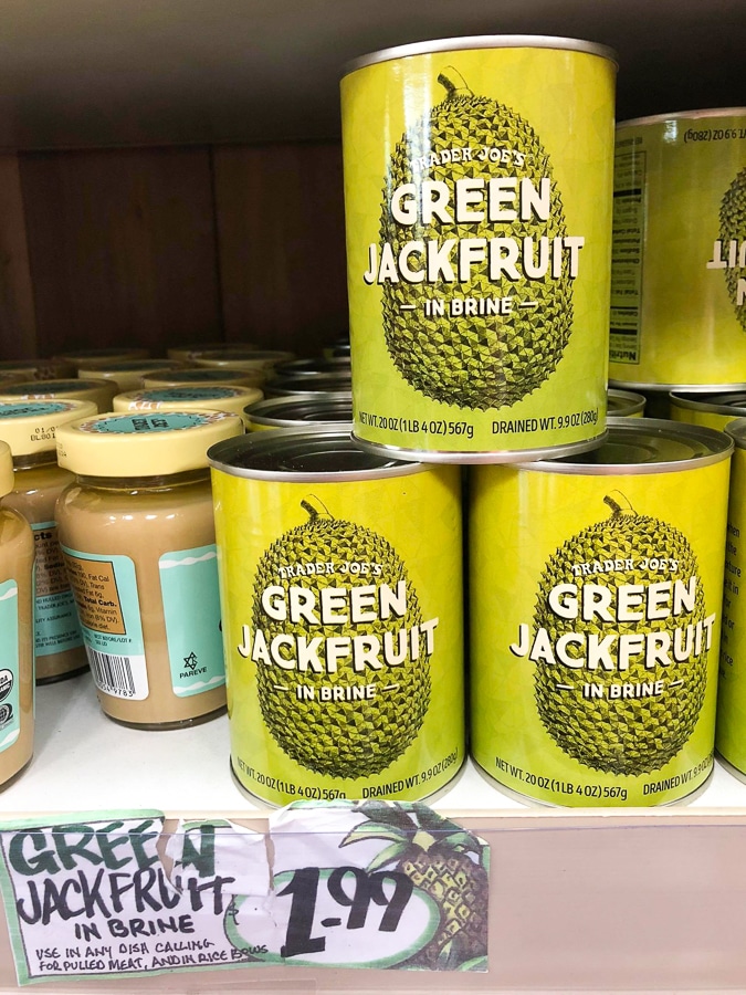 Cans of green jackfruit for $1.99 each on a shelf at Trader Joe's.