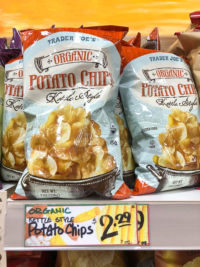 Bags of organic kettle style potato chips on a shelf at Trader Joe's. 