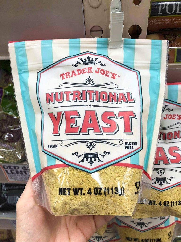 Bag of nutritional yeast hanging from a hook at Trader Joe's.