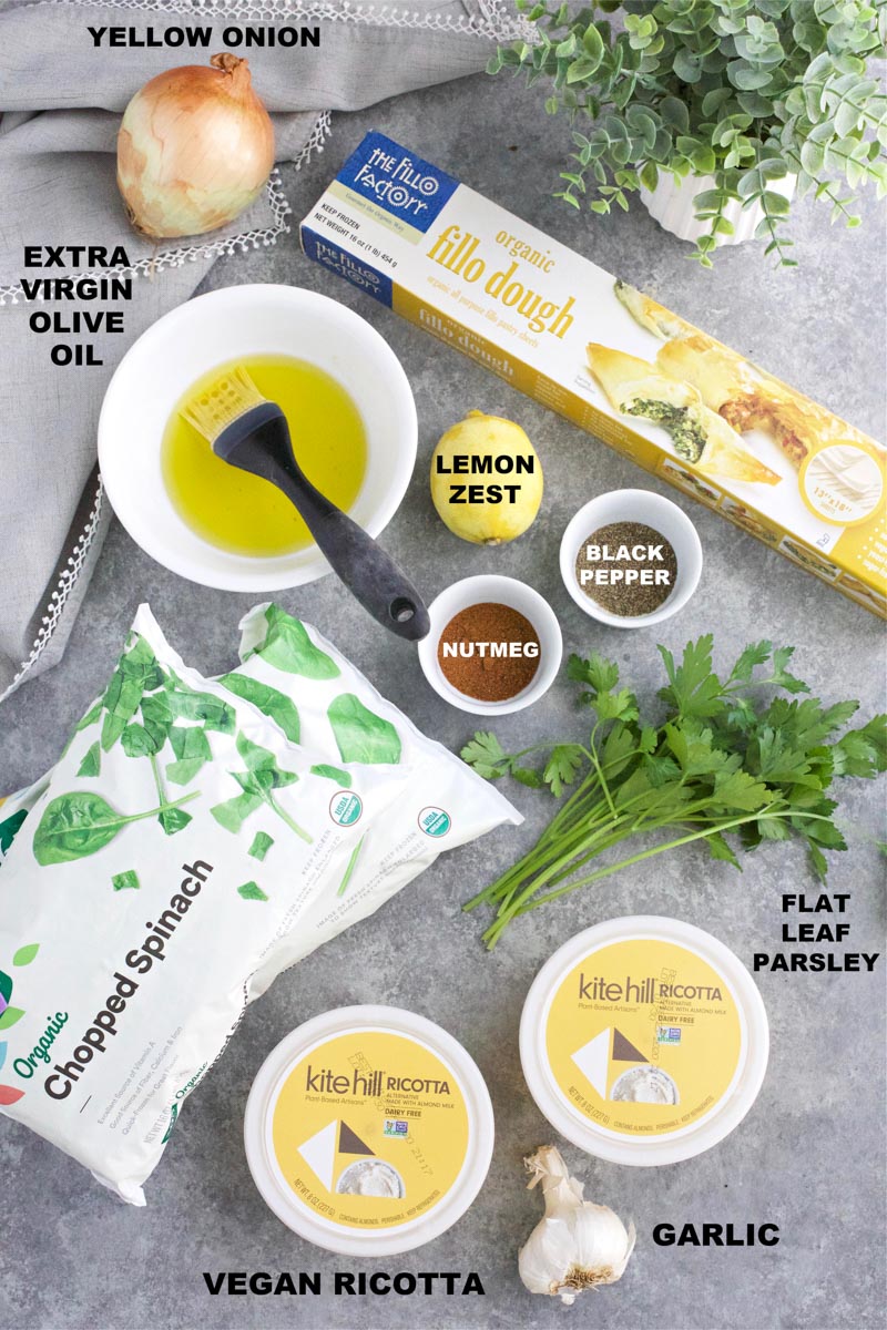 All of the ingredients needed to make the dish are laid out on a gray table.