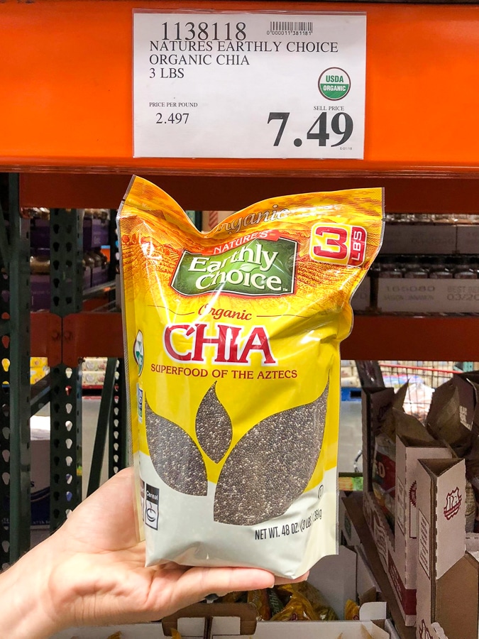 A hand holding a bag of organic vegan chia seeds for $7.49 at Costco. 