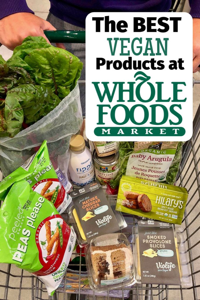 A person pushing a shopping cart filled with the best Whole Foods vegan products.