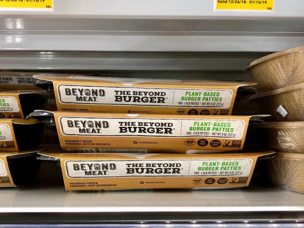 Three packages of Beyond Burgers on a shelf at Whole Foods. 