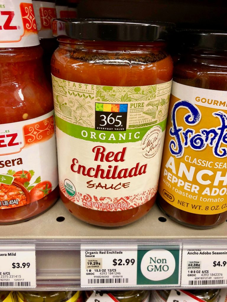 A jar of organic red enchilada sauce on a shelf at Whole Foods. 