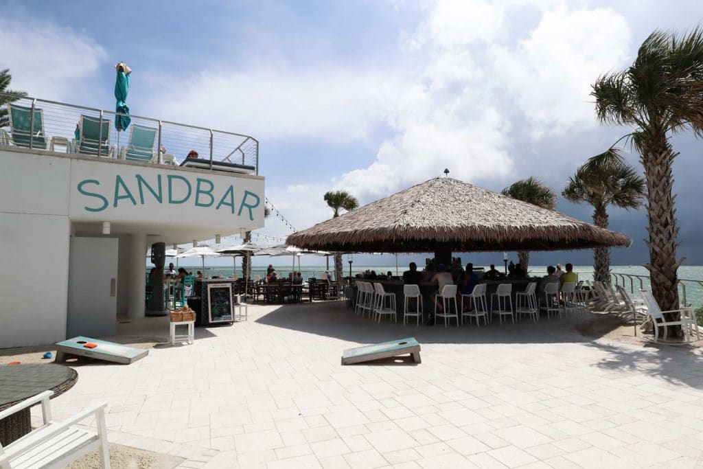 The Sandbar tiki hut and bar overlooking the water at the Opal Sands Resort. 