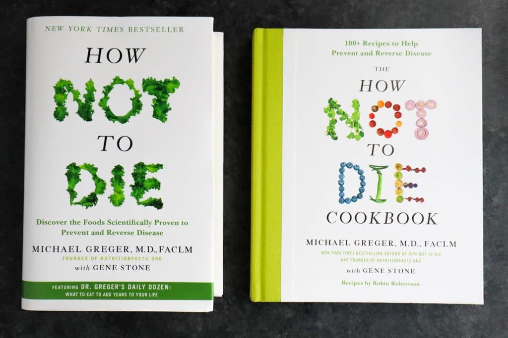 How Not to Die and the How Not to Die Cookbook next to each other on a dark background.