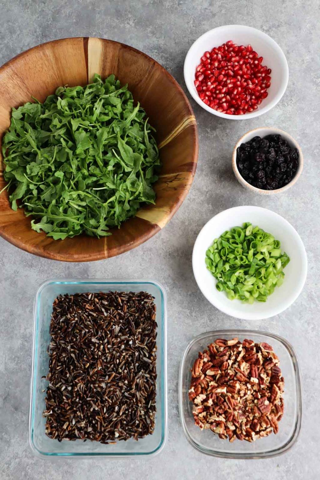 All of the ingredients to make the recipe laid out in bowls on a gray table top.