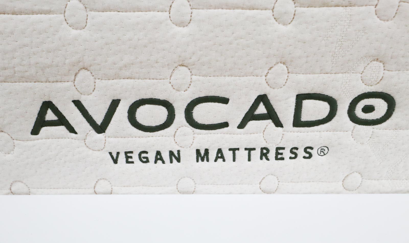 A close up picture of the Avocado Vegan Mattress label on a mattress.