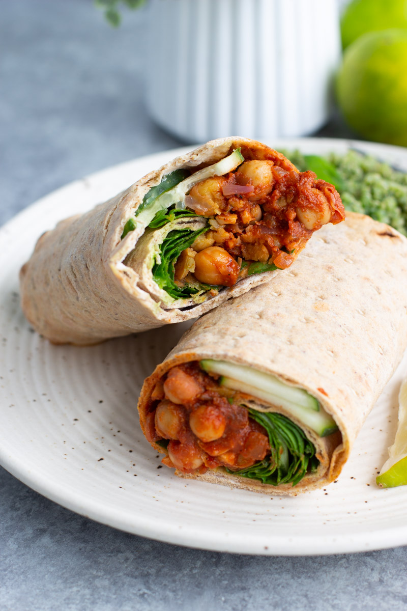 Two halves of a lavash wrap on a plate. 